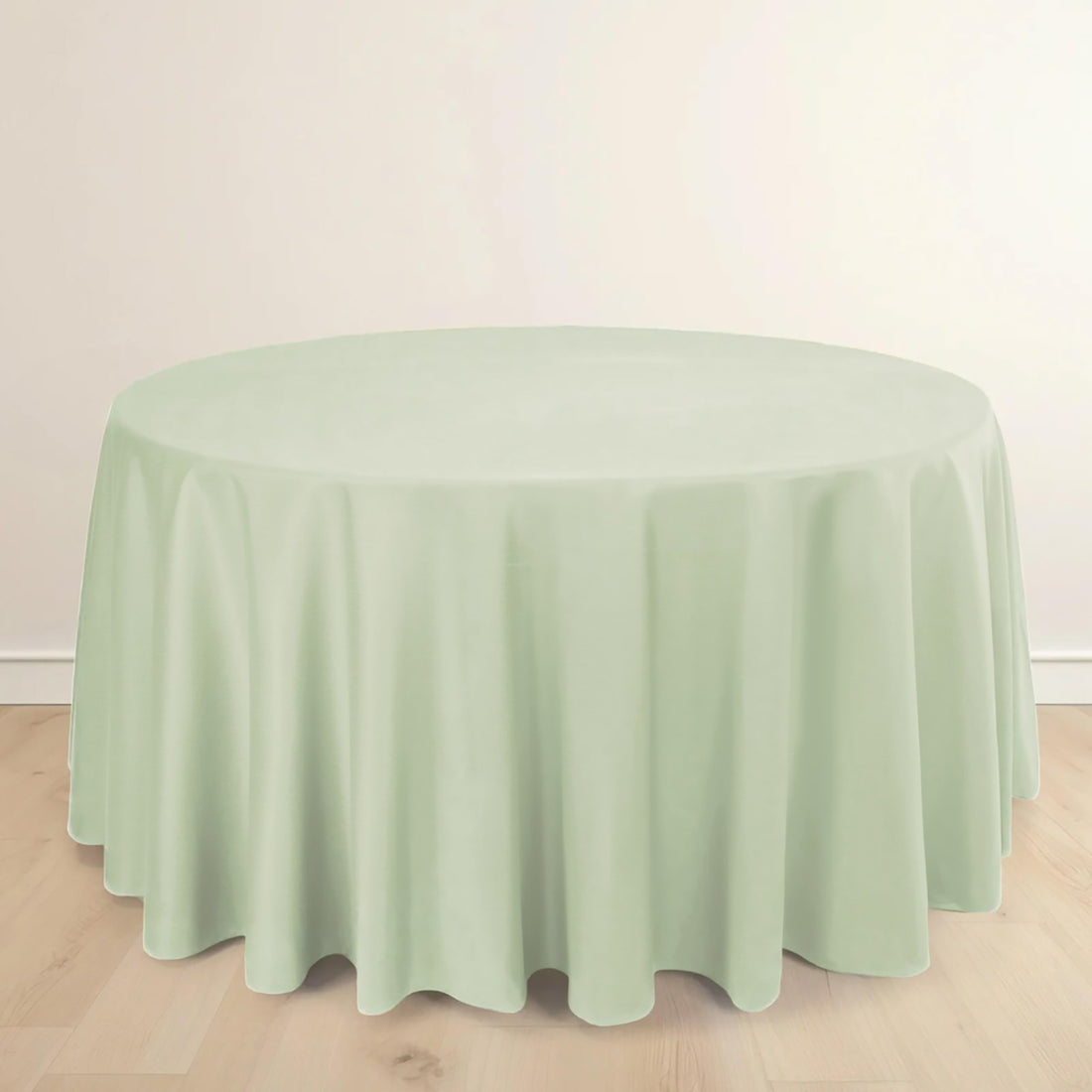 Round mint green tablecloth on a plain background.