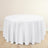 Round white tablecloth with elegant draping on a wooden surface.