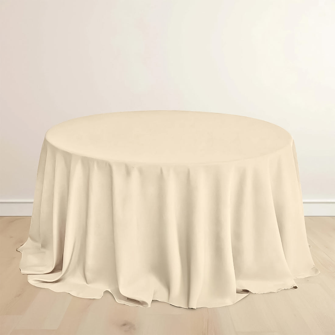 Round beige tablecloth on a wooden floor.