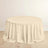 Round beige tablecloth on a wooden floor.