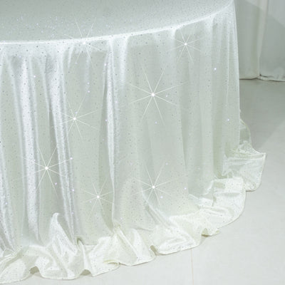 Sparkling white tablecloth with ruffled edges and shimmering details.