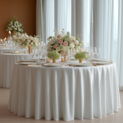 Elegant wedding reception table with floral centerpieces and glassware.
