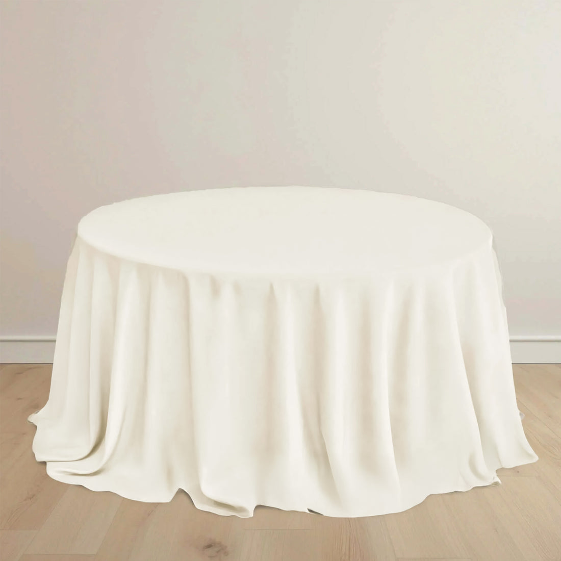 Round table with a soft, white tablecloth draping elegantly.