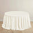 Round table with a soft, white tablecloth draping elegantly.