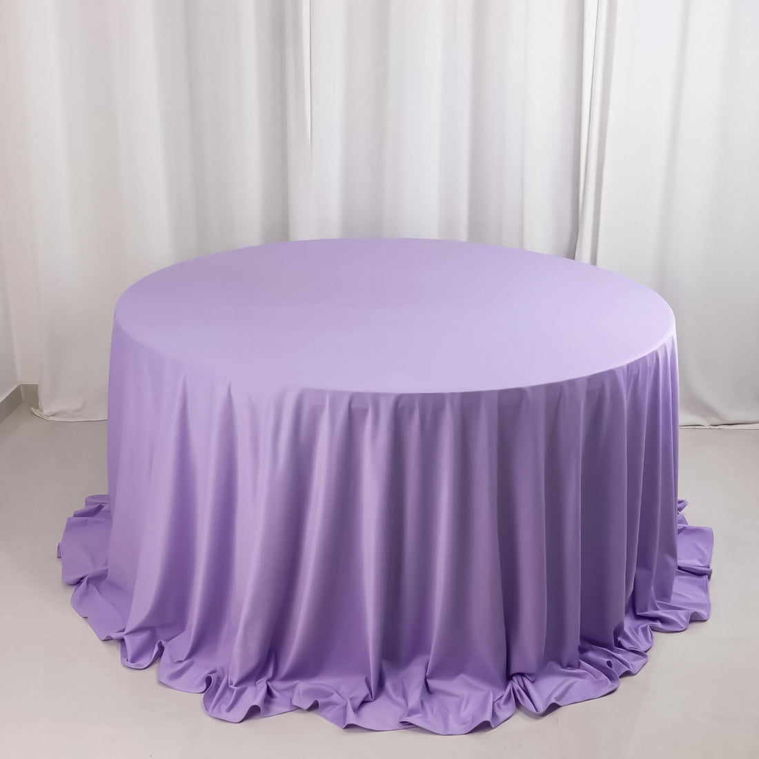 Round lavender tablecloth with elegant draping.