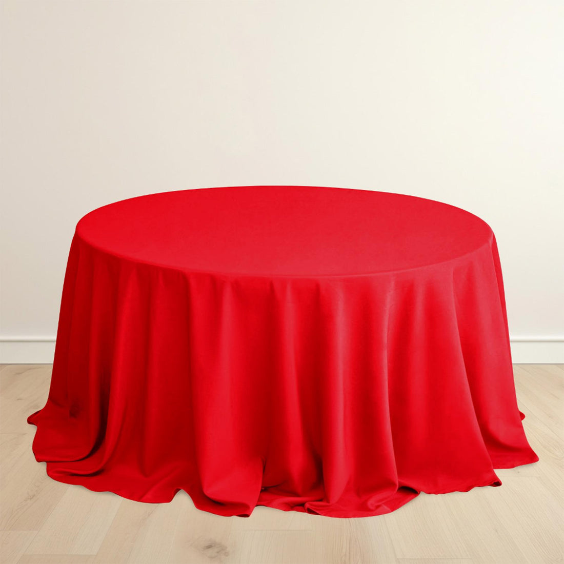 Red round table with elegant draping fabric.