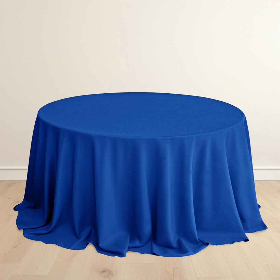 Round blue tablecloth on a wooden floor.