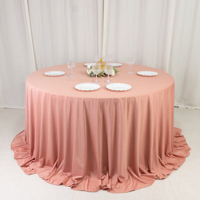 Pink round table with white plates and glasses in elegant event setup