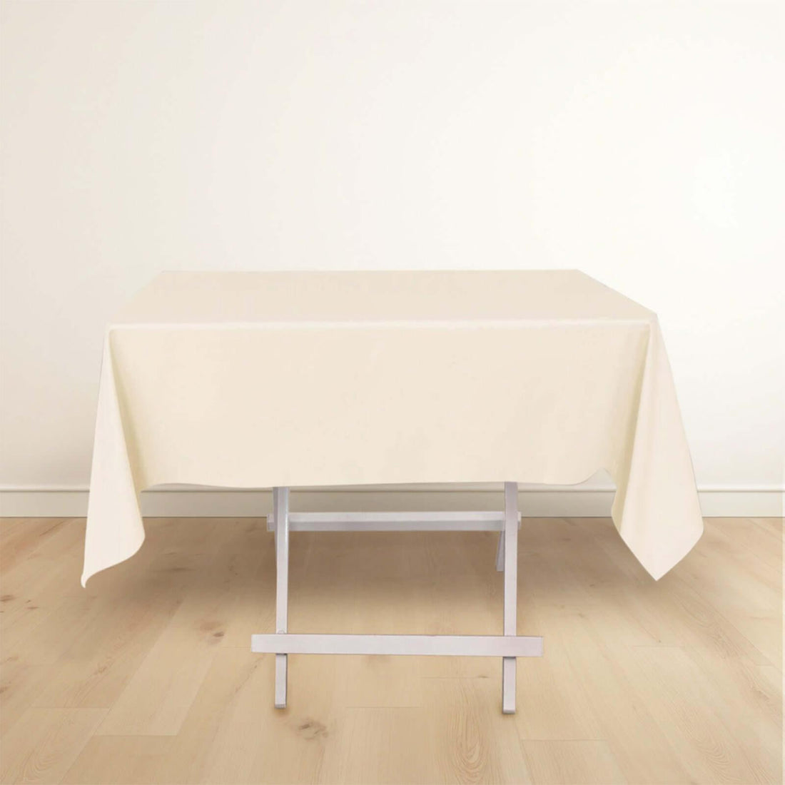 Cream tablecloth draped on a white folding table.