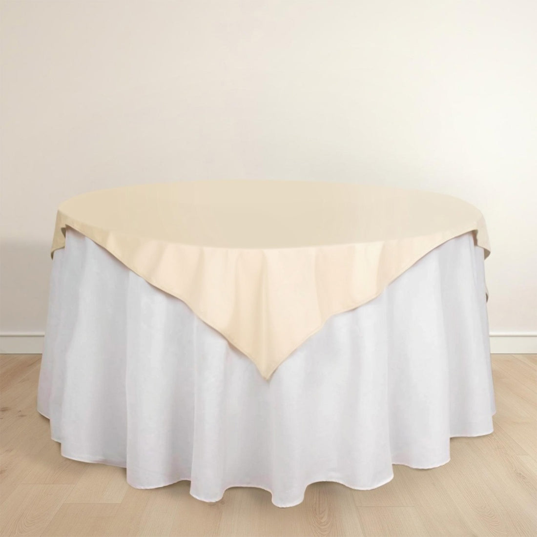 Round table with beige and white tablecloth draping elegantly.