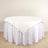 Round table with a white tablecloth draping elegantly around the edges.