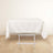 White tablecloth draped over a folding table on a plain background