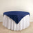 Navy tablecloth draped over a round table with white skirt