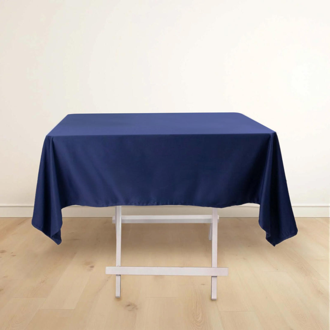 Navy blue tablecloth draped over a white folding table