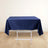 Navy blue tablecloth draped over a white folding table