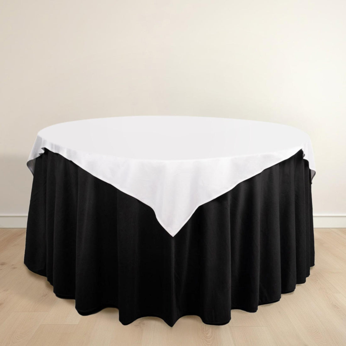 Round table with black skirt and white tablecloth