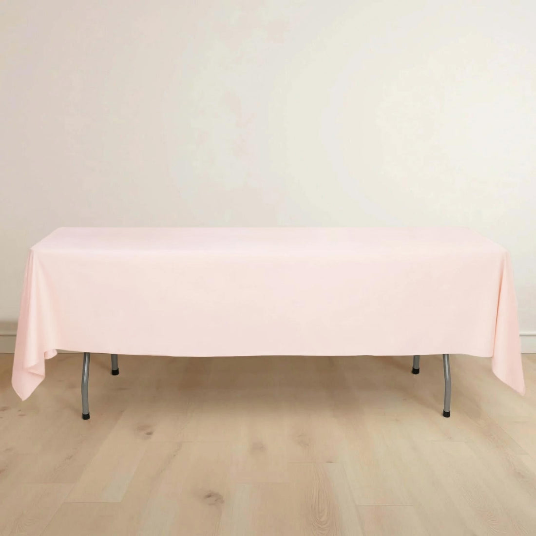 Pink tablecloth draped over a table against a plain background.