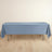 Blue tablecloth draped over a folding table on a light wooden floor.