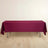 Burgundy tablecloth draped over a table in a minimalist setting.