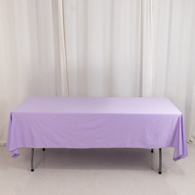 Purple tablecloth draped over a folding table in a studio setting.