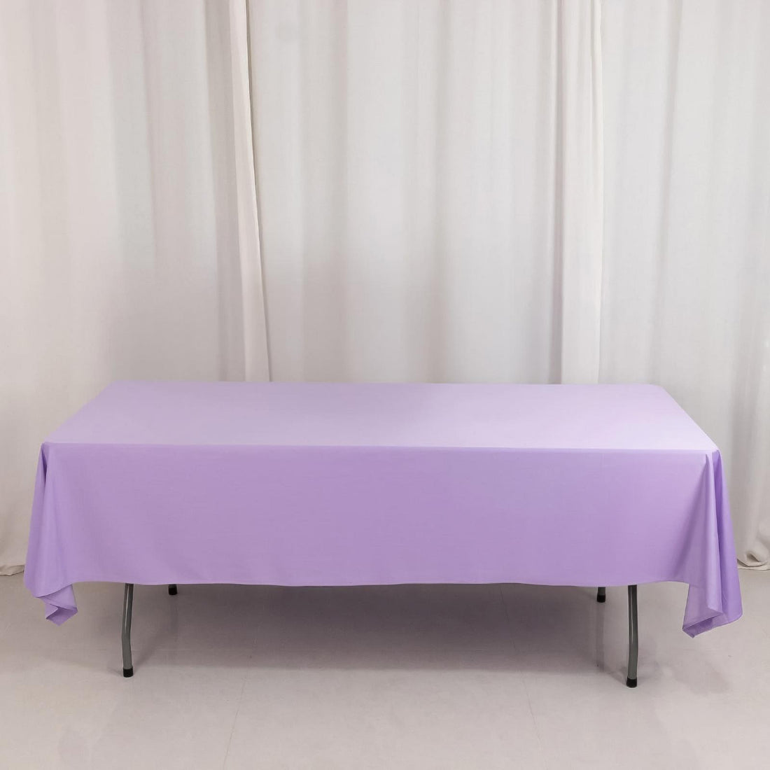 Purple tablecloth draped over a table in a studio setting