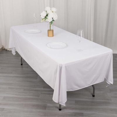 White tablecloth draped over a dining table with elegant decor