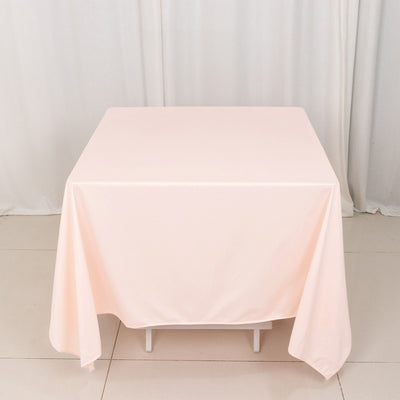 Pink tablecloth draped elegantly over a table in a studio setting