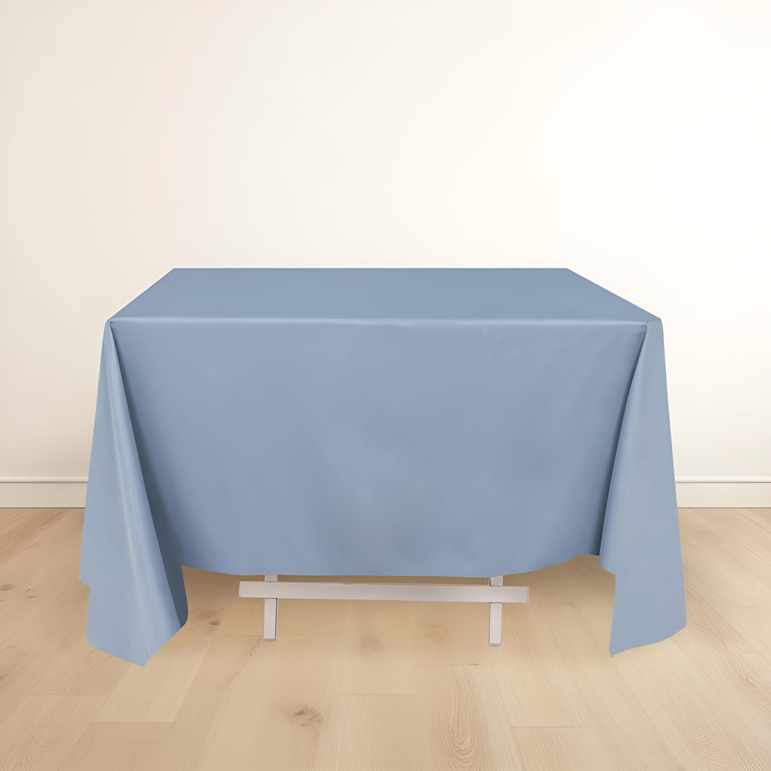 Blue tablecloth draped over a table in a minimalistic setting.