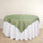 Round table with green satin overlay and white tablecloth.