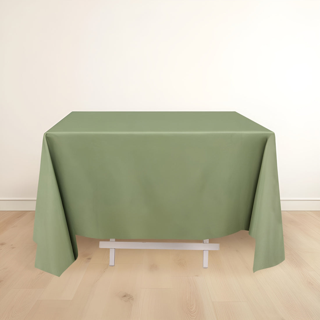 Green tablecloth on a white table against a light background.