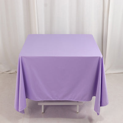 Purple tablecloth draped over a table in a studio setting.