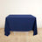 Navy tablecloth draping over a table in a minimalist setting.