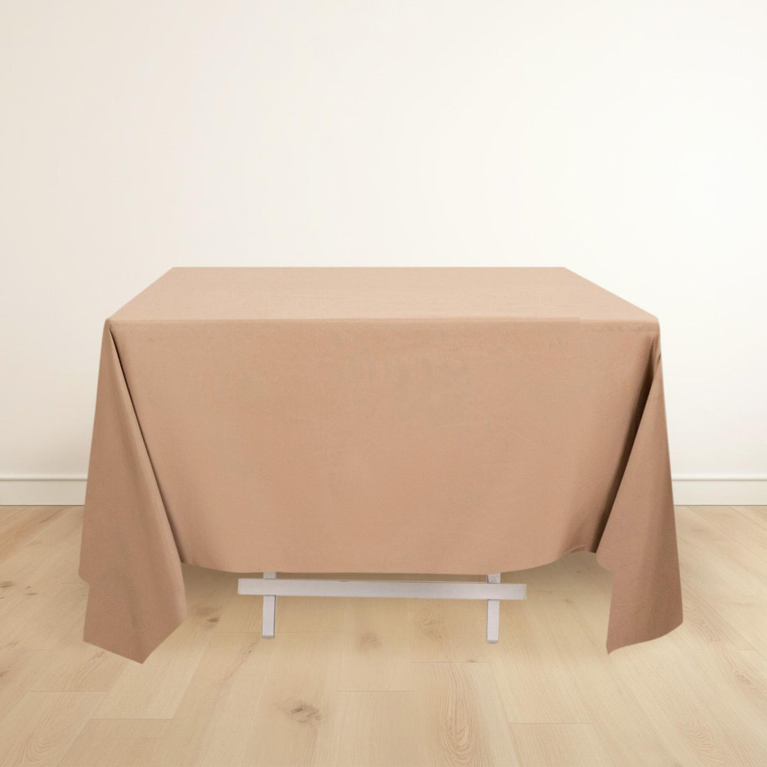 Brown tablecloth draped over a table in a light setting.