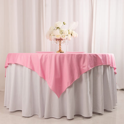 Elegant table setup with pink and white linens and floral centerpiece.
