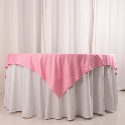 Pink tablecloth draped elegantly over a white table.