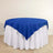 Blue tablecloth on a round table with white skirt.