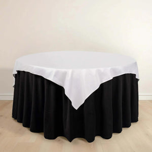 Round table with black skirt and white tablecloth