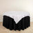 Round table with black skirt and white tablecloth
