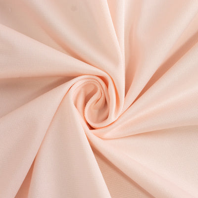 Peach textured fabric swirl showcasing soft material detail.
