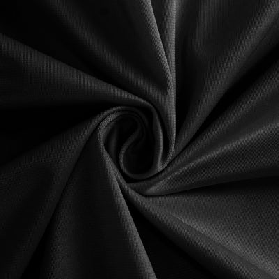 Black textured fabric in a swirling pattern.