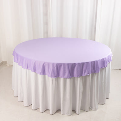 Purple round tablecloth with ruffled edges on a white table.