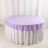 Round table covered with a lavender tablecloth and white skirting.
