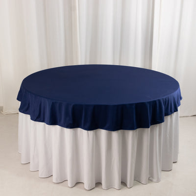 Round navy tablecloth with white ruffled skirt, ideal for events.