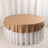 Round table with a beige tablecloth on a white skirt