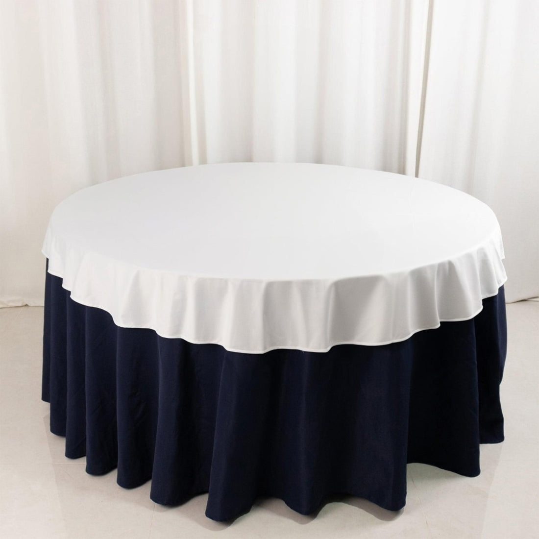 Round table with white top and navy blue skirt