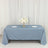 Elegant blue tablecloth with white plates and floral centerpiece