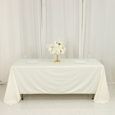 Elegant white table set for a formal event with floral centerpiece.