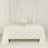 Elegant white table set for a formal event with floral centerpiece.