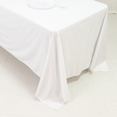 White tablecloth draped over a table in a minimalistic setting.