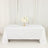 Elegant table setup with white tablecloth and floral centerpiece.